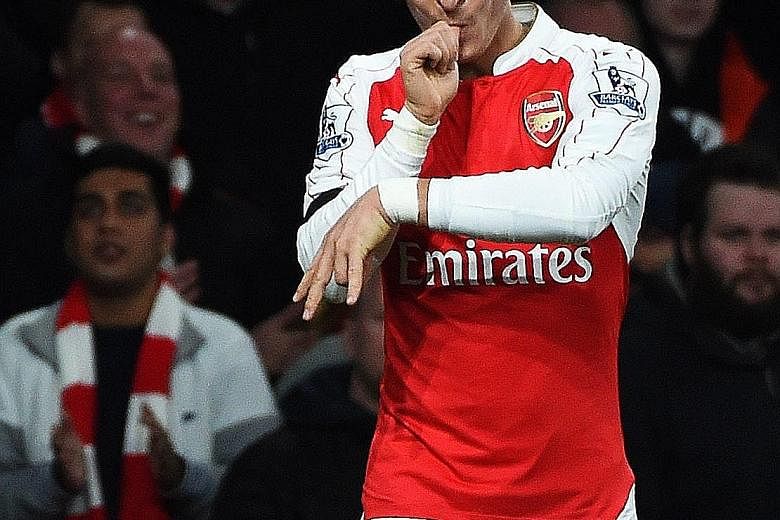 Mesut Oezil celebrating after scoring against Bournemouth on Monday. The Arsenal midfielder gets pleasure out of providing accurate passes too as he believes both goals and assists eventually benefit his team.
