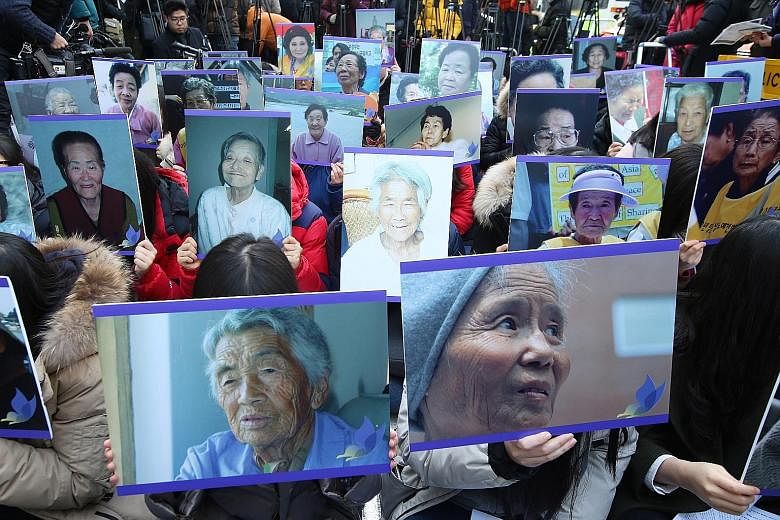 South Korean protesters with pictures of deceased former comfort women during a weekly anti-Japan rally in front of the Japanese Embassy in Seoul. The plight of South Korea's comfort women is a hugely emotional issue that has for decades marred ties 