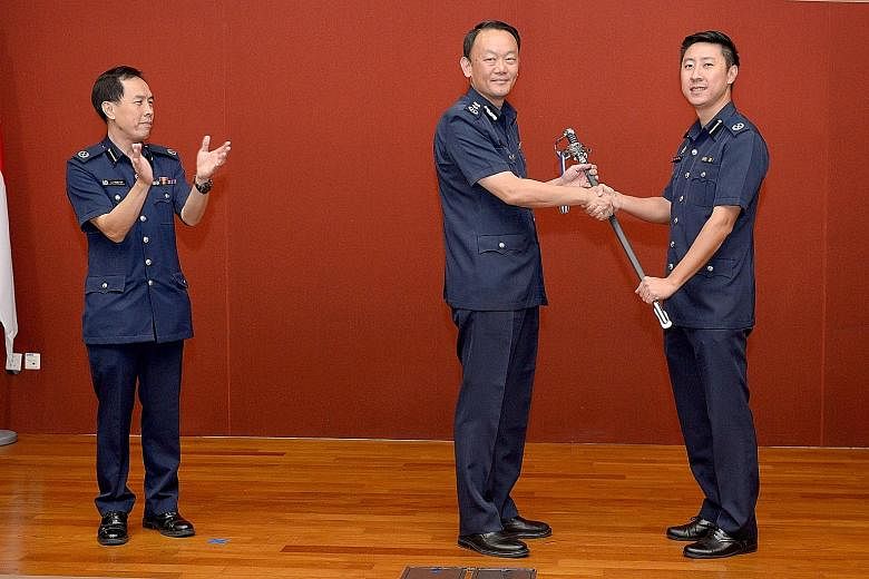 From left: Deputy Assistant Commissioner (DAC) Lu Yeow Lim's command of Tanglin Division being symbolically handed over via Police Commissioner Hoong Wee Teck to DAC Tan Chia Han in a ceremony yesterday. DAC Tan will assume his role tomorrow, while D