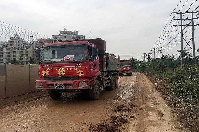 (Left) Trucks loaded with soil leaving the site of the landslide. Nearby resident Chen Yulin (above) says the incident is "a man-made tragedy that could have been prevented".