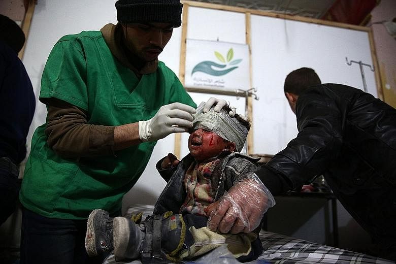 A child receiving treatment in a makeshift hospital following a reported air strike by Syrian government forces on the rebel-held town of Douma on the eastern edge of the capital Damascus on Wednesday. Syria's war has forced more than four million pe