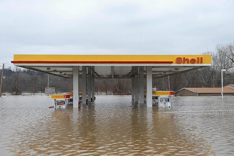 A petrol station is partly submerged on Route 141 in Fenton, Missouri. Water rose to the rooftops of homes and businesses in the state, with Governor Jay Nixon calling the flooding "historic and dangerous".