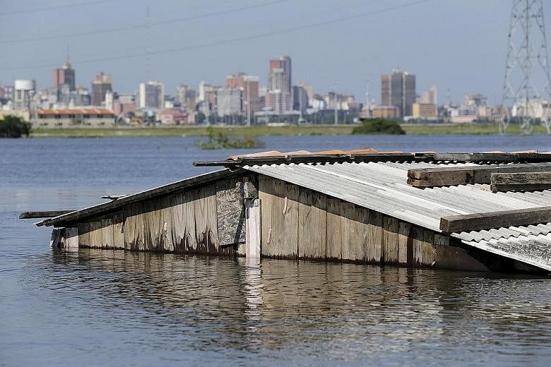 A house nearly submerged in floodwaters in Paraguay's capital, Asuncion, on Wednesday.