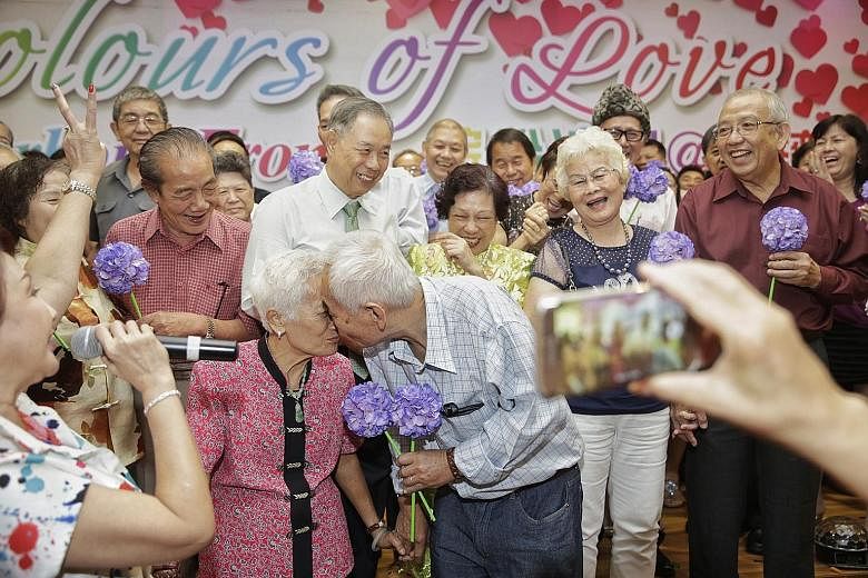 Mr Chuang Pek Chow and Madam Foo Swee Moy renewing their vows with a kiss alongside other couples at Colours of Love, an event aimed at celebrating marriage and family life. Madam Foo, who believes the secret of their marriage is mutual compromise, s