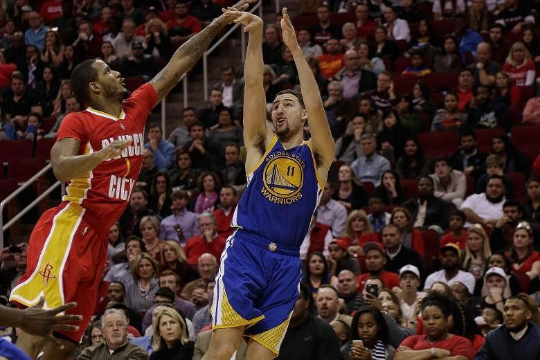 Golden State's Klay Thompson shooting a fade-away jumper over Houston's Trevor Ariza. The guard scored 38 points and won his individual battle with James Harden.