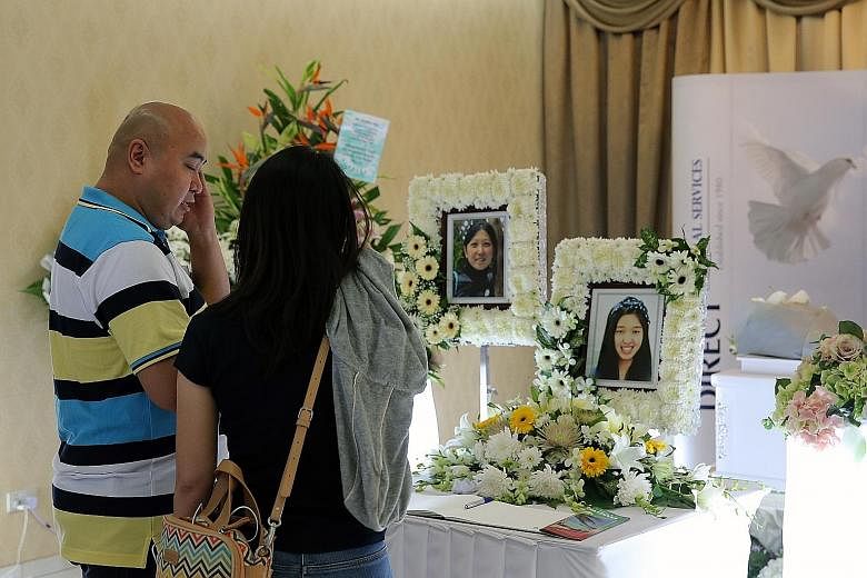 Mr Stephen Yap at the wake for his daughter Vivian yesterday. The 16-year-old died in a boating accident in the Maldives with her mother Nicole Tsai. Madam Tsai was cremated in Sri Lanka and her remains sent to Taiwan. Her photo was placed near her d