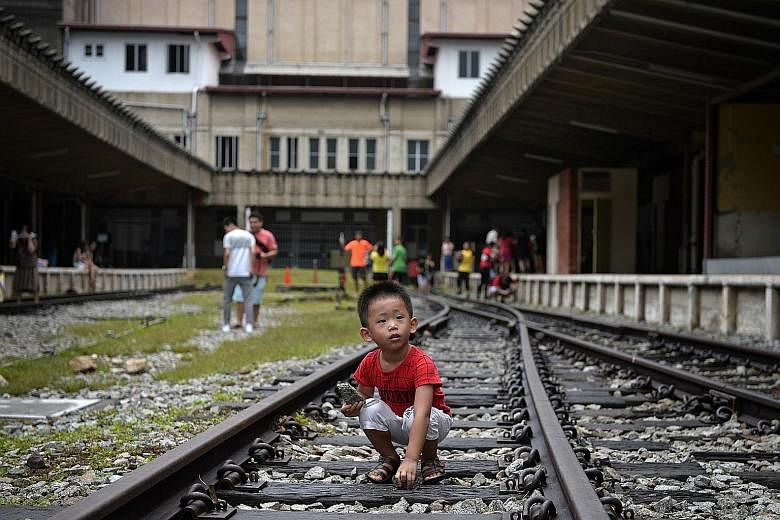 Three-year-old Zach Liu picking up stones at Tanjong Pagar Railway Station yesterday. The station will next be opened to the public on Feb 9.