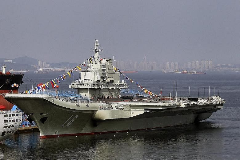 The Liaoning (left), China's first aircraft carrier, is a Soviet-made vessel bought in 1998. The second carrier will be designed and built in China and, like the Liaoning, will be conventionally powered.