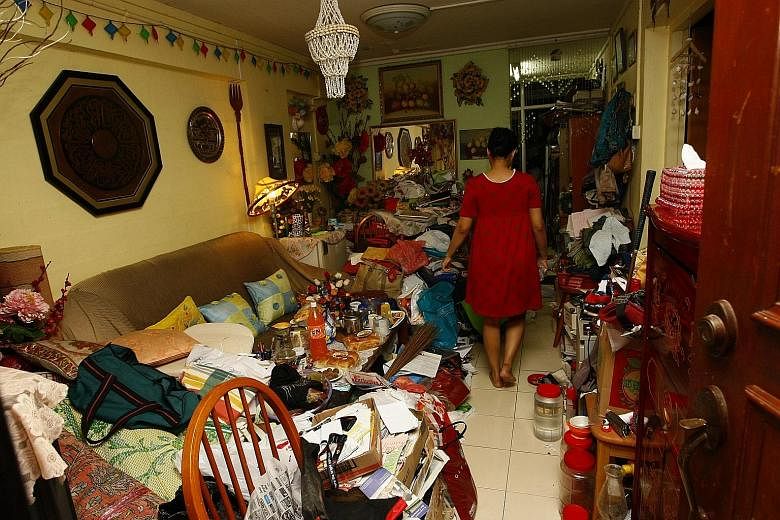 Above: Ms Julia seen here in 2010 in her two-room HDB flat which was filled with old newspapers, plastic bags, boxes and clothes. Left: Because there was no space for Ms Julia's mum, Madam Mainam Mahmud, to rest well at night, the elderly woman had t