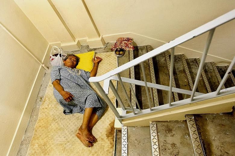 Above: Ms Julia seen here in 2010 in her two-room HDB flat which was filled with old newspapers, plastic bags, boxes and clothes. Left: Because there was no space for Ms Julia's mum, Madam Mainam Mahmud, to rest well at night, the elderly woman had t