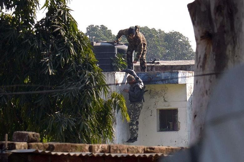 Indian security officers searching for gunmen who infiltrated an air force base in Pathankot yesterday. The operation to secure the base ended 14 hours after the militants, said to be from the Pakistan-based Jaish-e- Mohammed group, began the attack.