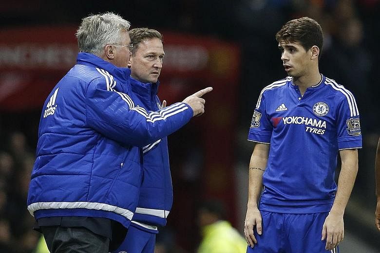 Interim manager Guus Hiddink (left, with first-team coach Steve Holland at Old Trafford on Monday) giving instructions to Oscar, who missed a penalty against Watford on Boxing Day. Chelsea's players will have to lift their game against a resolute Cry
