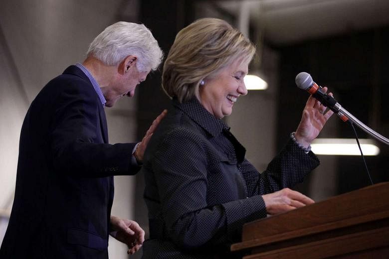 Democratic presidential candidate Hillary Clinton, and her husband and former President Bill Clinton share a moment on stage on Nov 15, 2015.