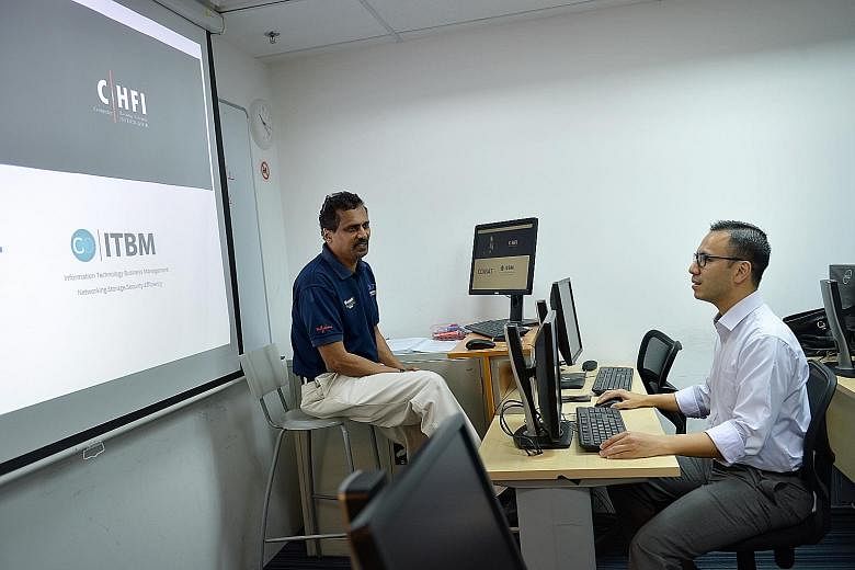 IT trainer Muthu Krishnan (at far left) and student Mohamad Ideal Ismail, who has been in IT for 15 years, both upgrade themselves constantly to keep abreast of industry trends.