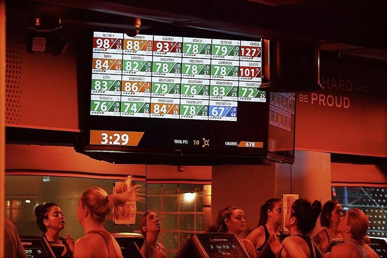 At Orangetheory fitness studios, monitors broadcast clients' performance to the whole class.