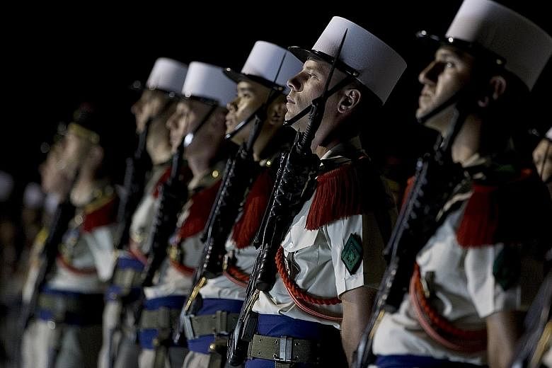 Members of the 13th Demi-Brigade of the French Foreign Legion forming a guard of honour during a visit by the French Defence Minister to the legion's base in the United Arab Emirates on Saturday. Minister Jean-Yves Le Drian was visiting French milita