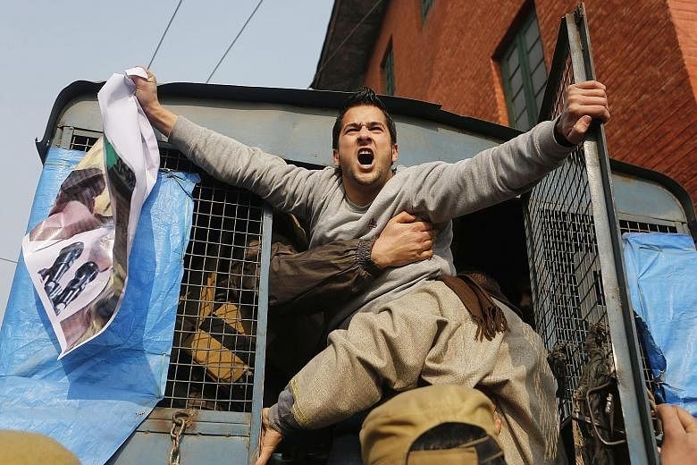 A Kashmiri Shi'ite Muslim shouting slogans while being removed by Indian police during a protest in Srinagar, in Indian Kashmir, yesterday over Saudi Arabia's execution of Shi'ite cleric Nimr al-Nimr.