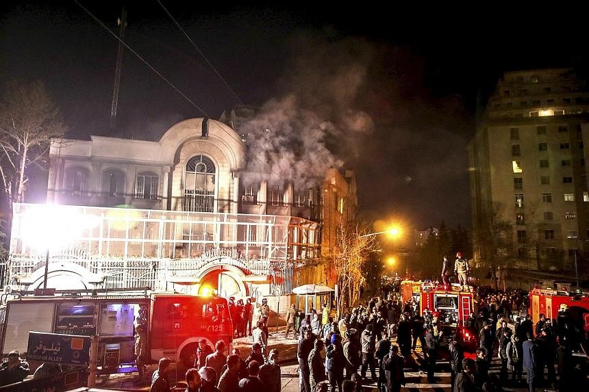 Smoke billowing out of Saudi Arabia's embassy in Teheran last Saturday after Iranian protesters threw petrol bombs at the building.