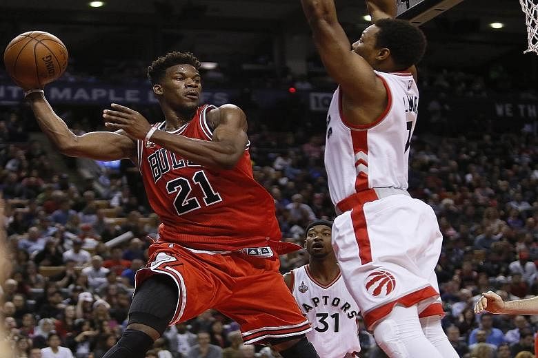 Bulls guard Jimmy Butler looking to pass the ball as Raptors guard Kyle Lowry defends at the Air Canada Centre. Chicago beat Toronto 115-113 after trailing by as many as 15 points, and Butler's 40 points in the second half beat Michael Jordan's 39-po