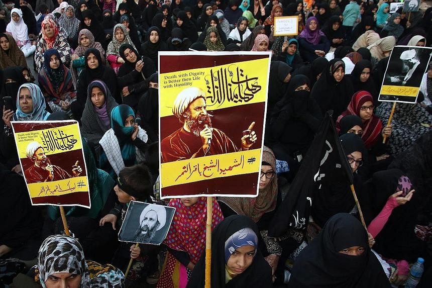 There have been protests in many places at the weekend against the execution of cleric Nimr al-Nimr, including (left) outside the Saudi Embassy in London and (below, left) in Karachi on Sunday. American Muslims protesting against Saudi Arabia's execu