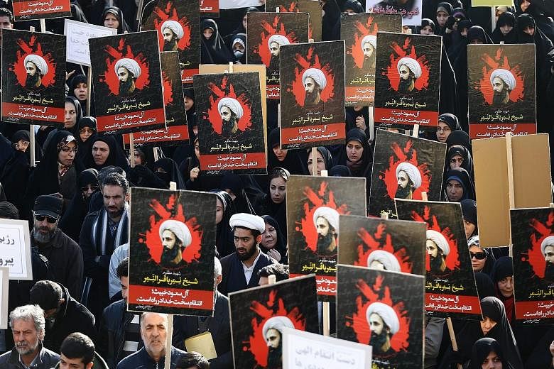 Protesters with posters of Shi'ite cleric Nimr al-Nimr rallied against Saudi Arabia in Teheran yesterday, after Riyadh executed the cleric along with others it accused of being Al-Qaeda members.