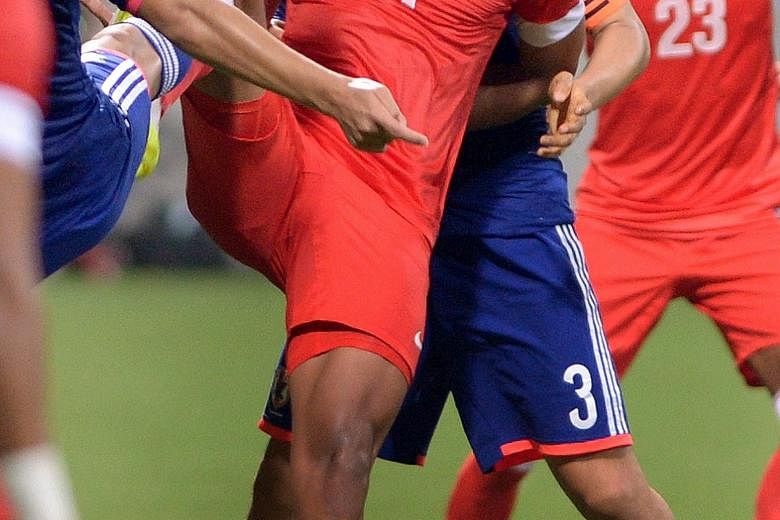 Irfan Fandi being closely watched by the Japanese (in blue) during a friendly match between the Singapore Under-23s and Japan Under-22s last year.