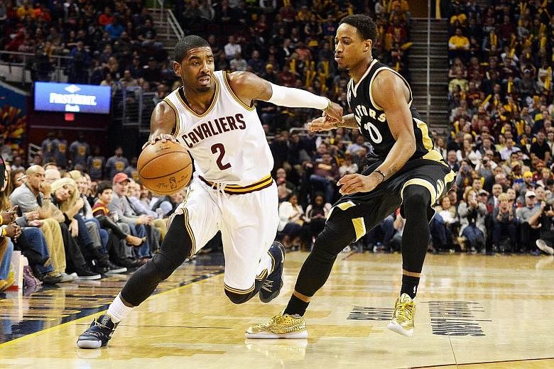 The Cleveland Cavaliers' Kyrie Irving dribbling past Toronto Raptors guard DeMar DeRozan during the fourth quarter at Quicken Loans Arena. The Cavaliers defeated the Raptors 122-100 for their fourth straight victory.