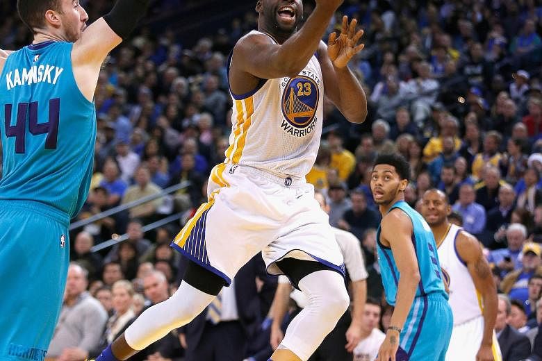 Draymond Green of the Golden State Warriors going up for a shot against Frank Kaminsky of the Charlotte Hornets at the Oracle Arena. The Warriors won the game 111-101, improving their season record to 32-2.