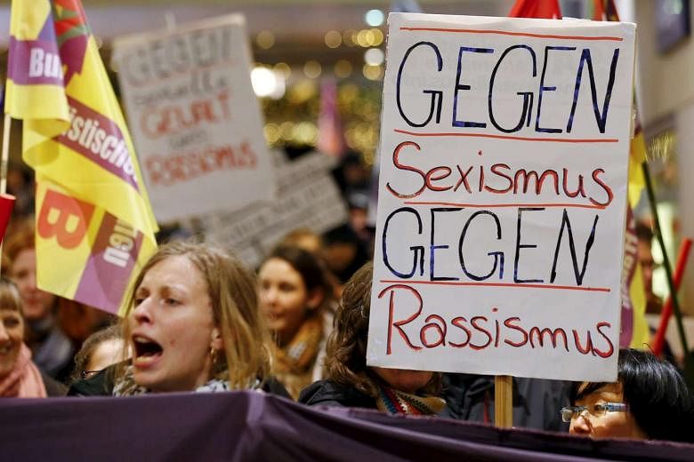 Protesters in Cologne, Germany with a placard that reads "Against Sexism - Against Racism" on Jan 5, 2016.