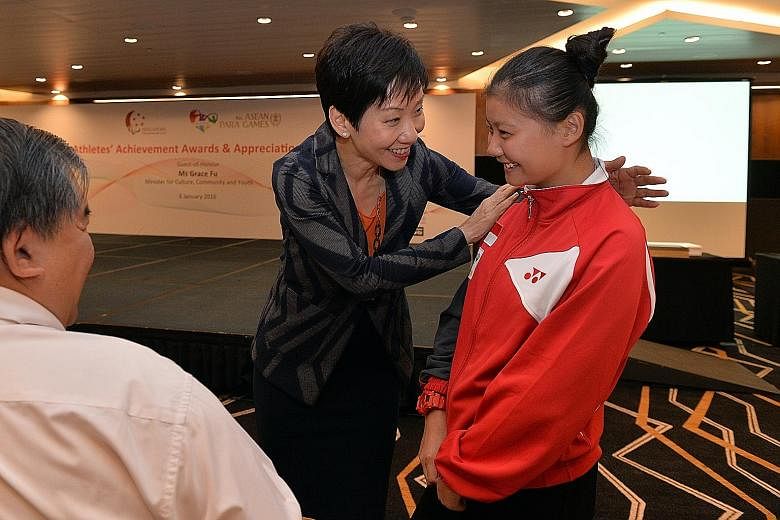 MCCY minister Grace Fu speaking with 15-year-old paddler Evelyn Lim, who is Singapore's youngest medallist at last month's Asean Para Games, during last night's Athlete's Achievement Award reception. The Republic's 156-strong APG contingent won a rec