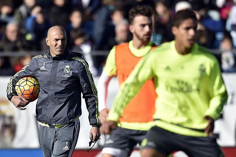 Zinedine Zidane (left) supervising a Real Madrid training session on Tuesday. The new manager is keen to keep all his star players happy and has reassured Welsh winger Gareth Bale, who was given a central role by previous boss Rafael Benitez, that he