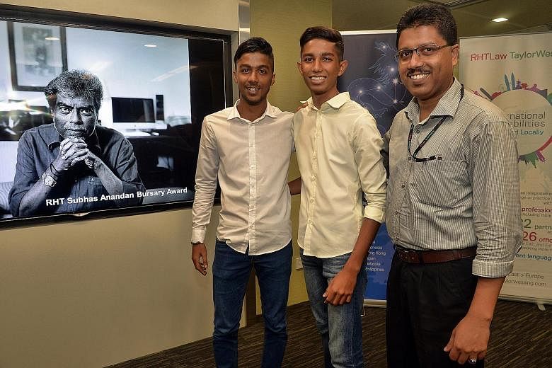 (From left) Abdul Khair and Muhammed Naasiruddin with their father Muhammed Zakkaria, who works as a dispatch clerk at RHTLaw Taylor Wessing. Mr Zakkaria's sons received the RHT Subhas Anandan Bursary Award.