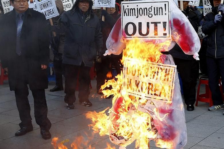 South Korean activists burning an effigy of North Korean leader Kim Jong Un yesterday during a rally in Seoul, after Pyongyang said it tested a hydrogen bomb on Wednesday.