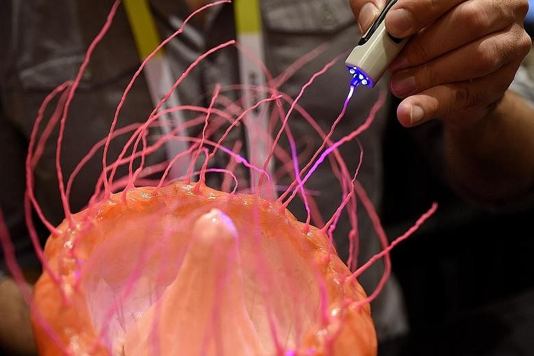 An exhibitor demonstrating a 3D drawing pen during the ShowStoppers section of the 2016 Consumer Electronics Show (CES) in Las Vegas this week. The CES is expected to bring a range of announcements from major names in technology showcasing new develo