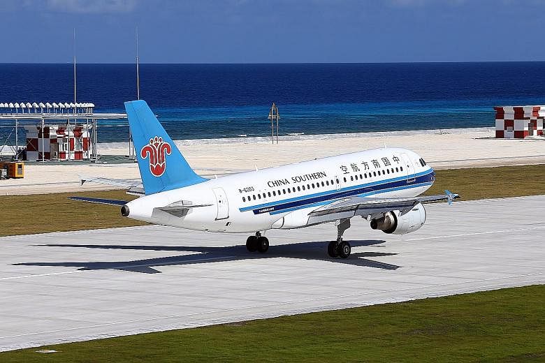 One of the two civilian planes - a China Southern Airlines Airbus - at the airport on Fiery Cross Reef on Wednesday. The two planes had flown from Haikou, the capital of the southern island province of Hainan, and touched down one after the other in 