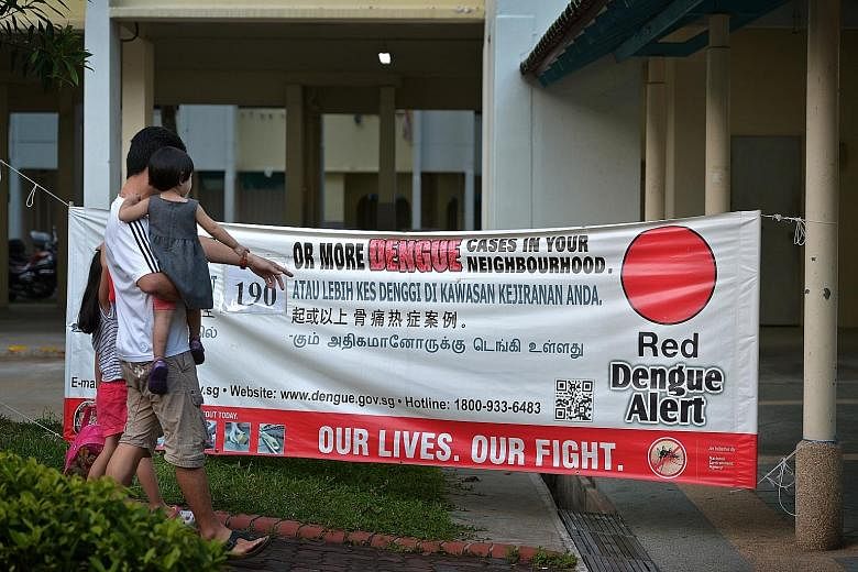 A banner showing the number of dengue cases at hot spots in Tampines Avenue 4. Tampines is Singapore's biggest dengue cluster. The NEA advised people living in active dengue clusters - there are 115 now - to use repellents to reduce their risk of get