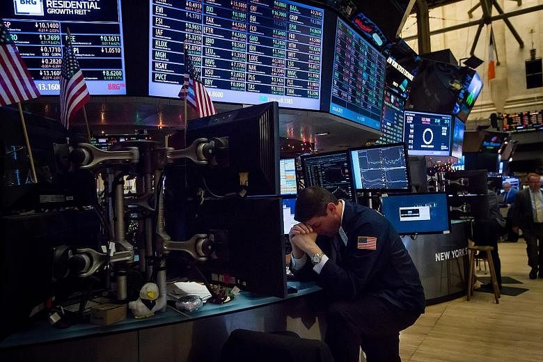 A trader on the floor of the New York Stock Exchange on Monday. Over the first four days of this week, more than US$4 trillion was wiped from the value of global equities.