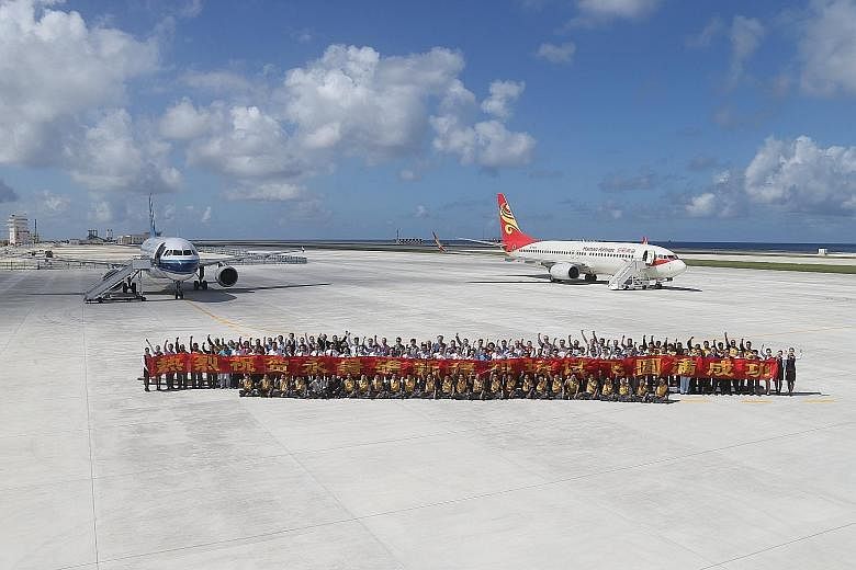 (Left) The two Chinese test flights that landed on Fiery Cross Reef, which China calls Yongshu Jiao, in the South China Sea on Wednesday. (Above) Hanoi maintains that the newly built 3,000m-long airstrip on the reef, which allows for bigger and heavi