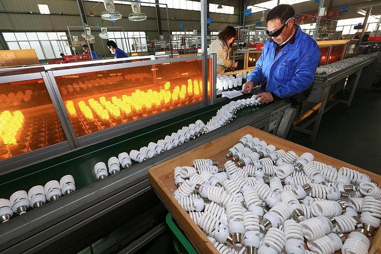 A lightbulb production line in a factory in Suining, Sichuan province. The basic problem with China's economic model, says the writer, is that it involves very high saving and very low consumption, and was sustainable only as long as the country coul