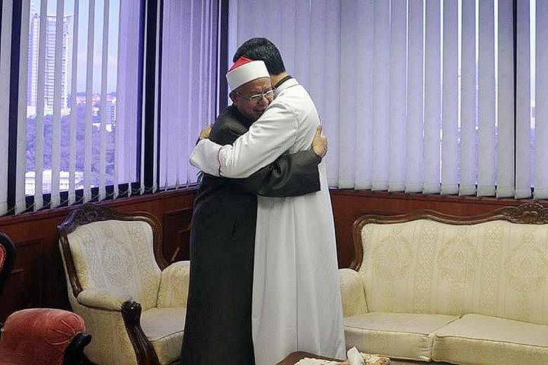 Mufti Zulkifli (in black) embracing Archbishop Leow in the ground-breaking meeting on Thursday. The two leaders shared views on the importance of being tolerant towards each other's religion.