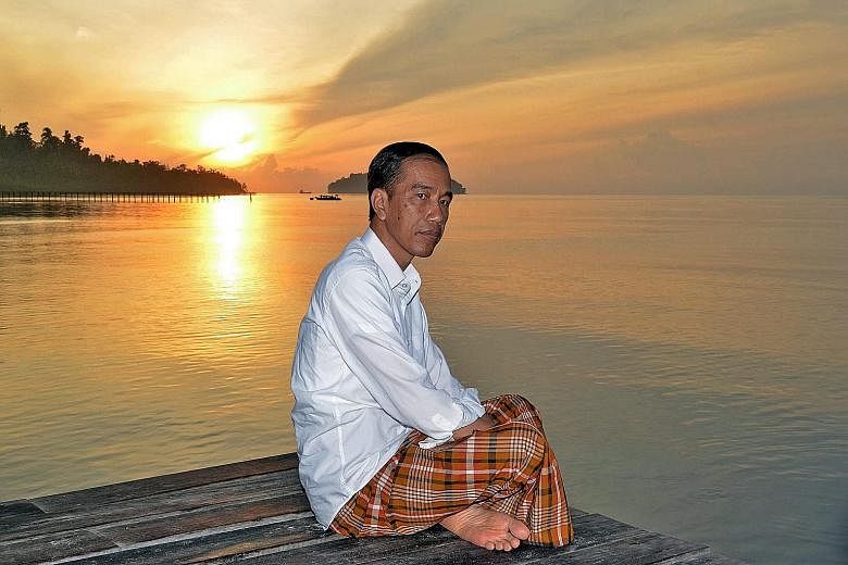 Indonesian President Joko Widodo enjoying the sunrise in Raja Ampat, West Papua, Indonesia, on Jan 1. Some critics have said the President seems to be placing greater value on realpolitik than reform.