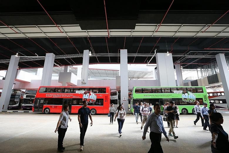 Buses painted in the proposed red and green for the fleet seen here at the Joo Koon Integrated Transport Hub.