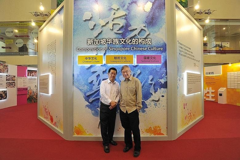 Clan federation chief executive Choo Thiam Siew (left) and exhibition adviser and curator Toh Lam Huat at a section of the show at the Singapore Conference Hall on Thursday. The multimedia showcase uses both English and Chinese text as well as photos