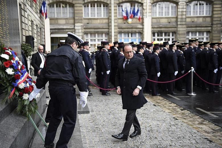 French President Francois Hollande at the Paris police headquarters on Thursday, where he laid a wreath in memory of those who died in the Paris terror attacks, one year after the attack targeting French satirical weekly Charlie Hebdo.