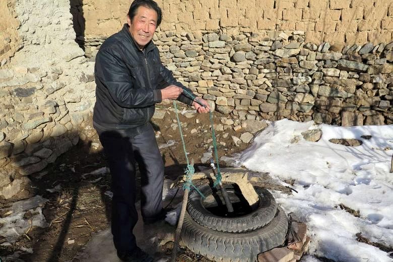 Aihetan villager Guo has to make six to seven trips to the well to fetch water each day as there is no piped water in the village. He and his wife survive on an annual income of about 2,000 yuan (S$440).