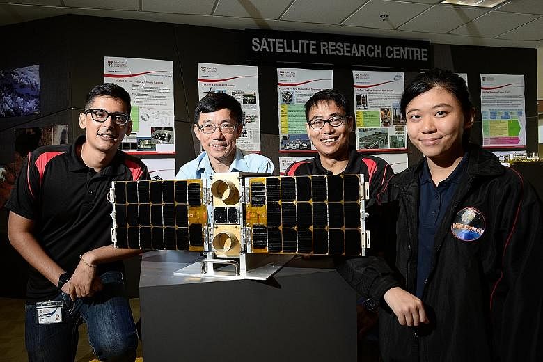 Research institutions here are geared up to tap into the opportunities offered by RIE2020. NTU, for example, has identified new areas of growth such as satellite development. Researchers are seen here with a model of a satellite recently launched int