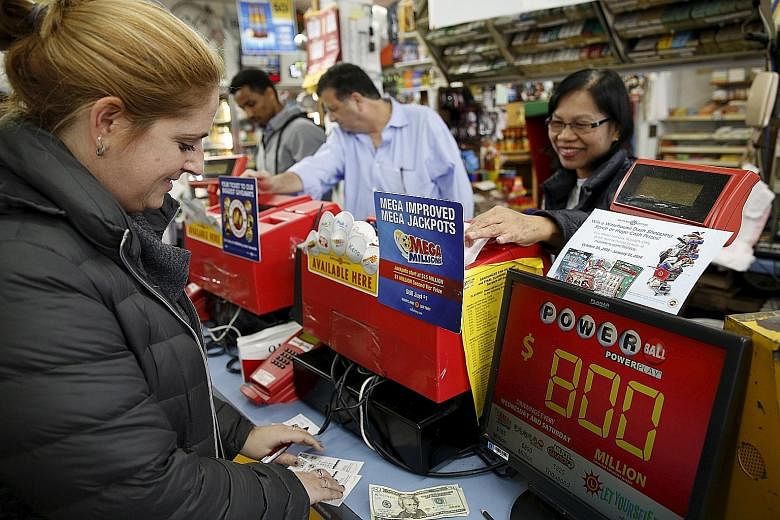 A customer buying Powerball lottery tickets in Bethesda, Maryland on Friday. The prize, which is currently worth US$800 million, is the largest in United States lottery history.