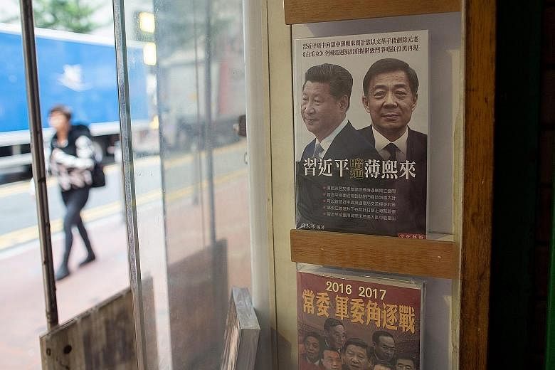 A book cover showing Chinese President Xi Jinping and former secretary of the Communist Party's Chongqing branch Bo Xilai is displayed in a window of the Causeway Bay Books.