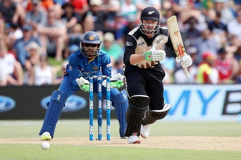 New Zealand's Colin Munro running between the wickets during the first T20 match as Sri Lanka's Dinesh Chandimal watches.