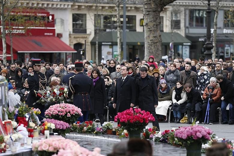 French President Francois Hollande, flanked by Paris Mayor Anne Hidalgo and French Prime Minister Manuel Valls, at Place de la Republique on Jan 10 to mark the march that took place in Paris on Jan 11 last year following the Charlie Hebdo attack.